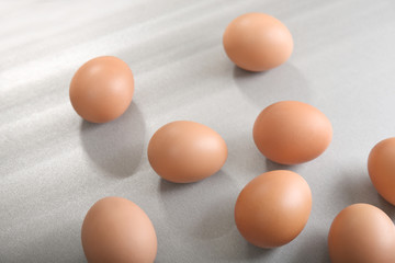 Raw eggs on grey background