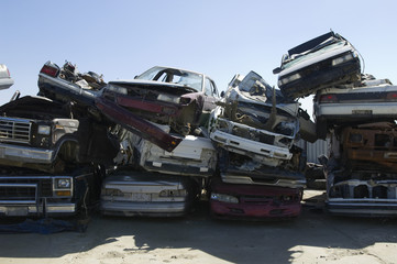 Stack of damaged cars in junkyard