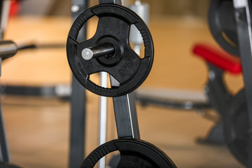 Fototapeta na wymiar Rack with weight plates in gym, close up