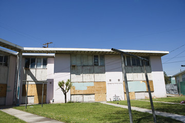 Exterior of an old abandoned house against blue sky