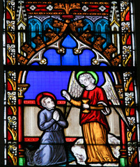 Fototapeta na wymiar Stained Glass - Angel giving Holy Communion
