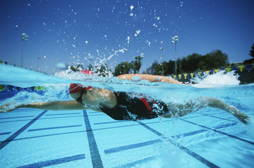 Professional female swimmer practicing before a competition