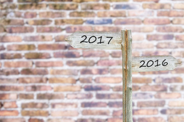 Wooden Blank Sign With Text 2017 and 2016, Over Blurred brick wa