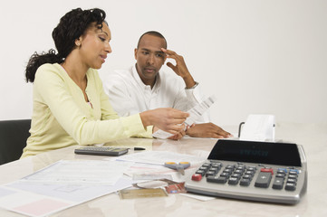 An African American couple planning their financial budget at home