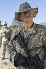 Fototapeta premium Armed US army soldiers with machine guns in field