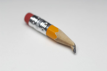Closeup of small broken pencil tip over white background