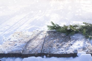 Spruce branches on a winter background with blurred bright light