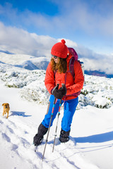 Girl with dog in winter mountains.