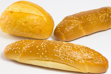 Bun and two baguette with sesame seeds and sunflower seeds on a