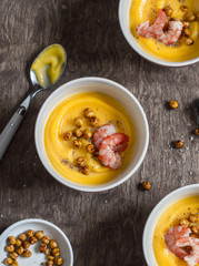 Pumpkin, spicy chickpea and shrimp soup. On a wooden table, top view. Flat lay