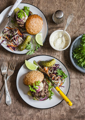 Dinner table - homemade burgers and coleslaw. Top view, flat lay