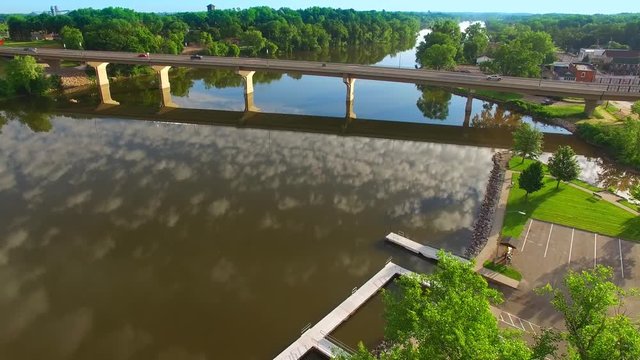 Stunning natural beauty; Clouds reflected in mirror smooth river surface under bridge, Wrightstown, Wisconsin.