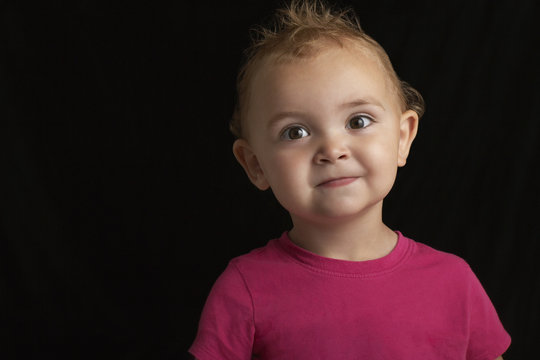 Closeup Portrait Of Adorable Baby Boy Against Black Background