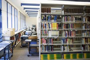 Books arranged on shelves in a high school library