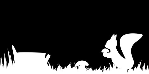 Silhouette of the squirrel in the grass.