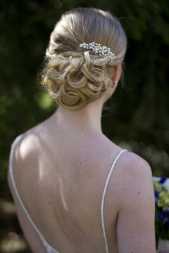 Wedding Photography: Bride with Blonde Hair in an Updo with Low Cut Back Wedding Dress