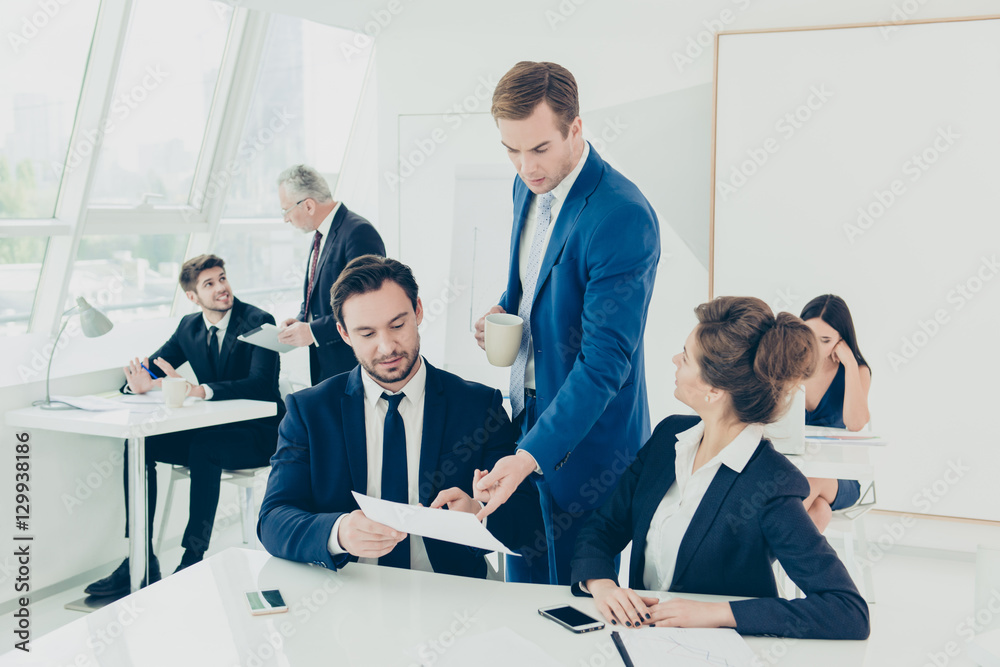 Wall mural executive manager looking on financial report making by two coll