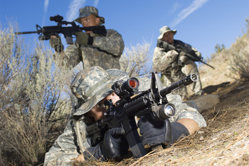 Soldiers armed with machine guns and ready to shoot