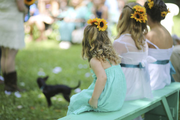 Wedding Photography: Flower Girls with Sunflowers in their hair watch processional with a black chihuaua dog in it