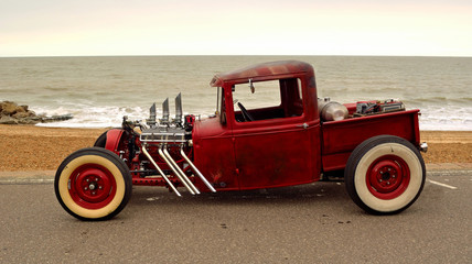 Classic Hot Rod  pickup truck on seafront promenade with sea in background - obrazy, fototapety, plakaty