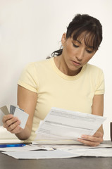 Woman figuring out bills at desk