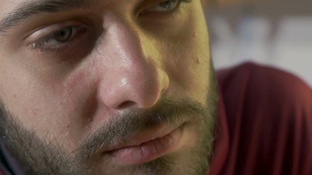 man sat at home inhaling a joint, beard