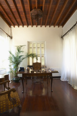 View of home office on hardwood floor in colonial style mansion