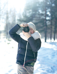 Child little boy photographer takes picture on the digital camer