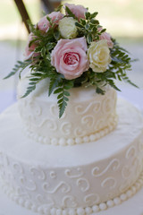 White Wedding Cake with Pink Roses and Peonies, Ivory Roses, and Fern Fronds