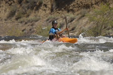 Caucasian man kayaking in river