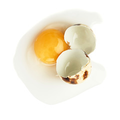 Cracked raw quail egg with yolk isolated over white background
