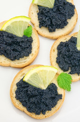 Tartine with caviar and lemon closeup