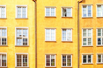 Fototapeta na wymiar Yellow facade with windows of the old building in Gdansk, Poland