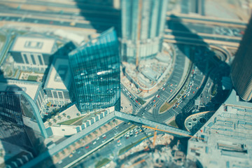 Fototapeta na wymiar Highway road intersection surrounded by skyscrapers, Dubai, sunny day, tilt shift shooting, view from top