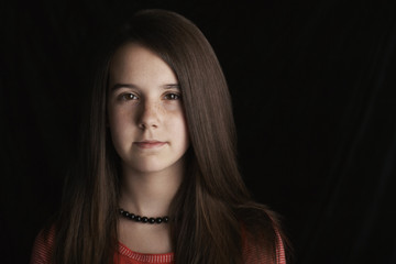 Fototapeta premium Closeup portrait of teenage girl isolated on black background