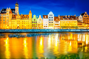 Fototapeta na wymiar Night view on the illuminated riverside with beautiful buildings of the old town in Gdansk, Poland