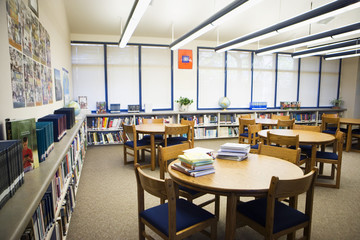 Tables and chairs arranged in an empty high school library