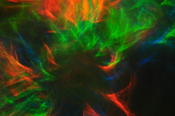 Abstract composition of dark colored smoke in the dark, red, blu