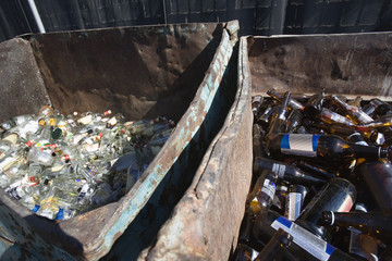 High angle view of thrown bottles in bin