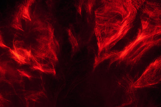 Abstract composition of red smoke in the dark