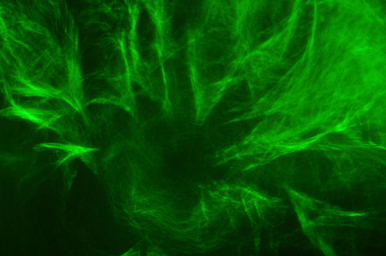 Abstract composition of green smoke in the dark