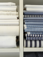 Fototapeta na wymiar Two piles of cotton towels on shelf