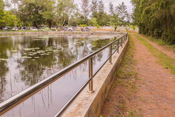 Fototapeta na wymiar Stainless balustrade surrounding pond for protection