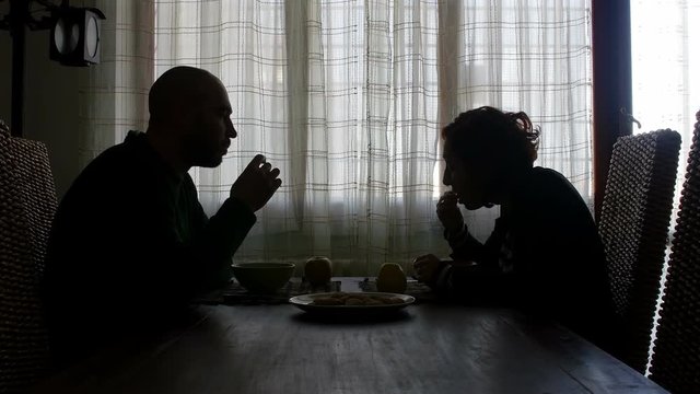 couple have breakfast in the morning, talking, milk and biscuits