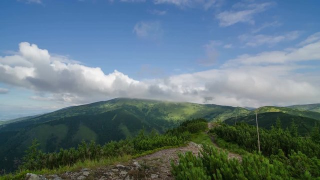 Beautiful white clouds flying over green mountains sky landscape time lapse