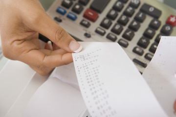 Closeup of woman with adding machine tape