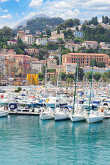 Fototapeta na wymiar colorful houses and yachts in Menton old town harbour, France