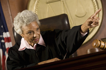 Senior female judge pointing in the courtroom