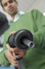 Low angle view of man holding petrol nozzle