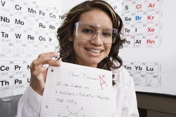 Portrait of a happy female high school student showing off good grade